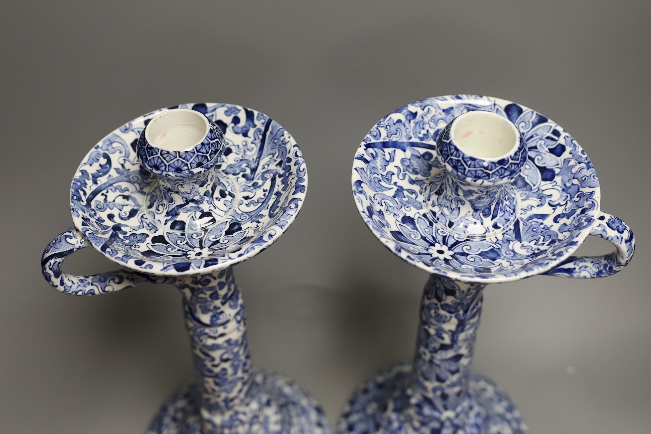 A pair of Wood & Sons tall blue and white candlesticks and a Delft blue and white cornucopia wall pocket (3), candlesticks 36 cms high
